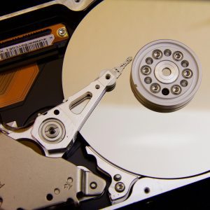 Detailed Close Up Of A Hard Disk Drive Showing The Actuator Arm And Data Platters.