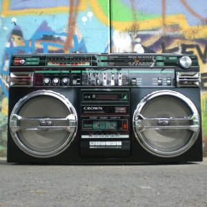 Classic Vintage Boombox Placed In Front Of A Vibrant Graffiti Covered Wall. Perfect For Retro Lovers.