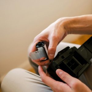 Close Up Of Hands Carefully Loading A Film Roll Into A Vintage Camera.