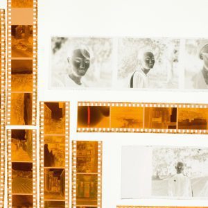 Film Negatives Arranged On A Light Table In A Flat Lay Style Displaying Various Images.