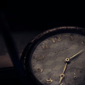 Close Up Of A Vintage Pocket Watch With A Textured Dial In A Moody Setting.