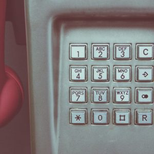 Close Up Of A Vintage Payphone Keypad With Pink Receiver, Highlighting Retro Technology.