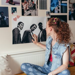 Teen Girl In Denim Fashion Enjoying Music In A Retro Inspired Bedroom.