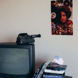 Retro Interior Featuring Vintage TV, Camcorder, And Music Posters.