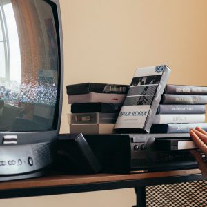 Vintage Scene With A VHS Player, Tapes, And An Old CRT TV Creating A Nostalgic Vibe.