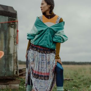 A Young Woman In Bohemian Fashion Poses Confidently Outdoors, Showcasing Eclectic Style.