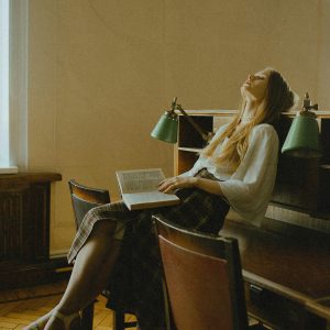 Woman Enjoying A Tranquil Moment With A Book In A Vintage Moscow Library Setting.