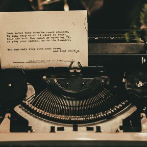 An Antique Typewriter Displaying A Typed Poem In A Nostalgic Sepia Tone.