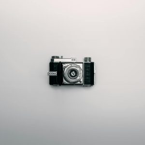 A Classic Kodak Camera Displayed Centrally On A Minimalist White Background.