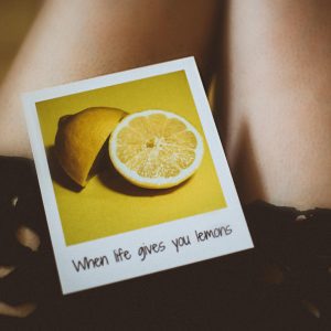 Artistic Shot Of A Lemon Themed Quote "When Life Gives You Lemons" On A Polaroid Against A Soft Background.