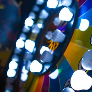 Close Up Of A Colorful Arcade Game Wheel With Bright Lights And Vivid Colors In Focus.