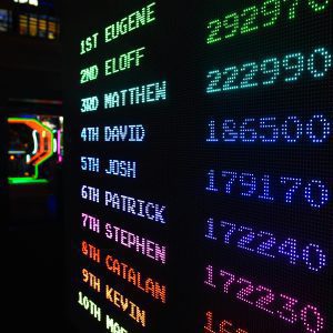 Colorful Illuminated Arcade Scoreboard Displaying High Scores In A Vibrant Gaming Ambiance.