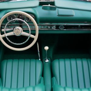 Vintage Mercedes Car Interior Featuring Green Seats And Dashboard, Highlighting Classic Automotive Design.