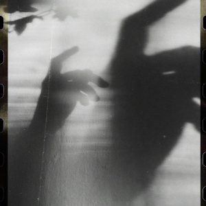 Black And White Shadow Play With Hands Creating Abstract Eerie Shapes On A Light Background.