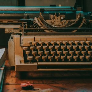 Close Up Of A Vintage Typewriter On A Wooden Desk With Classic Design Elements.