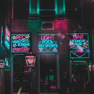 Dynamic Neon Lit Bar Facade In Amsterdam's Vibrant Nightlife District.