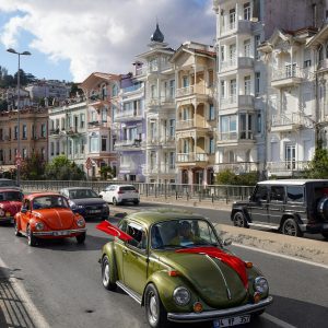 Classic Volkswagen Beetles On A Sunny City Street In Turkey With Colorful Historic Buildings.
