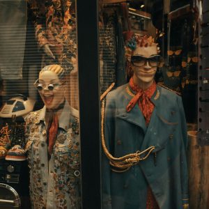 Quirky Mannequins Adorned In Eclectic Fashion Pieces Inside A Vibrant Store Display.