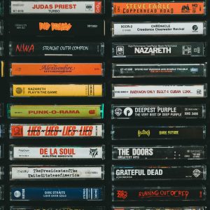 A Nostalgic Display Of Vintage Cassette Tapes Featuring Iconic Bands And Albums From The Past.