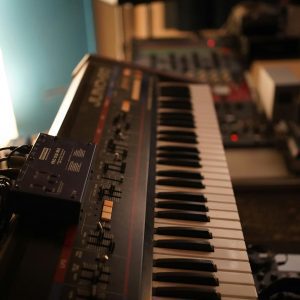 Close Up Of A Vintage Synthesizer Keyboard In A Dimly Lit Professional Music Studio.