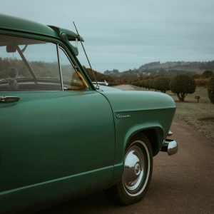 A Classic Green Car Parked Outdoors In The Scenic Landscapes Of Portland, Oregon.