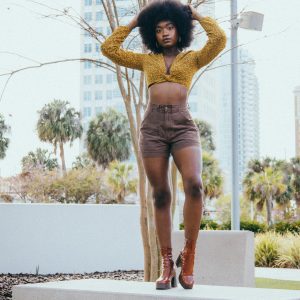 Confident Woman In Trendy Outfit Posing On A Bench In Downtown Tampa, Florida.