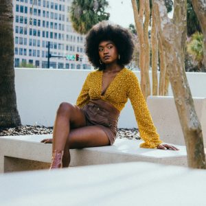 Fashionable Woman With Afro Hairstyle Posing On A Sunny Day In Tampa.