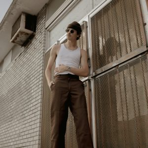 Stylish Male Model In Urban Setting, Showcasing Retro Fashion And Cool Vibes.