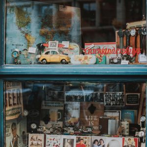 Charming Window Showcasing Vintage Maps, Toy Cars, And Memorabilia In Brussels.