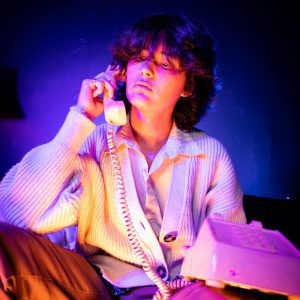 Young Adult With Vintage Style Calling On A Retro Phone In Dramatic Artificial Lighting.