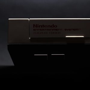 A Retro Close Up Shot Of A Classic Nintendo Entertainment System In Low Light.