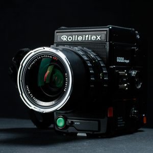 Detailed Shot Of A Classic Rolleiflex Camera With Lens And Dark Backdrop.
