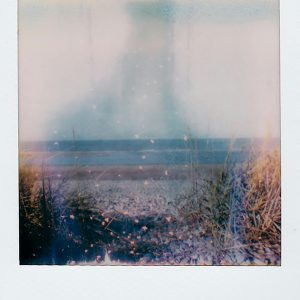 Vintage Style Polaroid Capturing A Hazy, Dreamy Beach Scene With Retro Aesthetics.