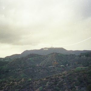 A Nostalgic Film Photograph Showcasing The Iconic Hollywood Sign And Surrounding Hills In Los Angeles, California.