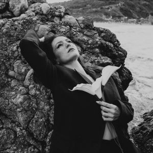 Artistic Black And White Portrait Of A Woman With A Flower By A Rocky Seaside In Türkiye.
