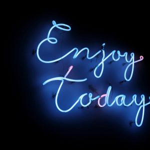 Bright Blue Neon Sign With The Phrase 'Enjoy Today' On A Dark Background, Creating A Vibrant And Uplifting Atmosphere.