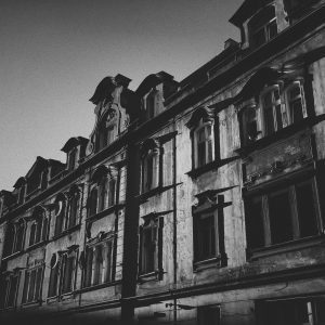Black And White Photo Showcasing The Vintage Architecture Of A Historic Building In Poznań, Poland.