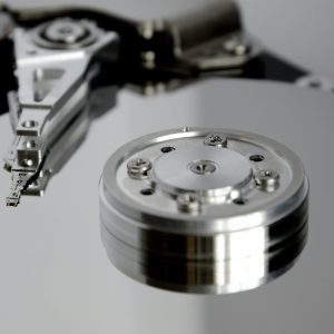 Detailed View Of Hard Drive Mechanism Showcasing Metallic Precision Parts.