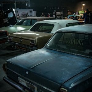A Collection Of Vintage Cars On Display Indoors, Highlighting Classic Automotive Design.