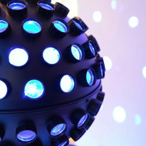 Vibrant Blue Disco Ball Glowing In A Dimly Lit Room, Perfect For Party Themes.