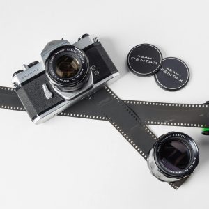 Classic Pentax Film Camera And Lenses With Photographic Film. Ideal For Vintage Photography Collections.
