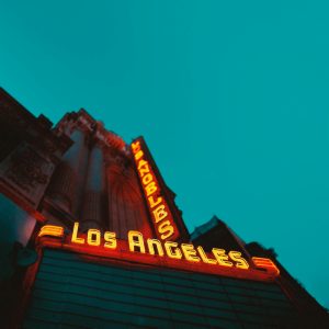 Capture Of A Vintage Los Angeles Neon Sign Illuminated At Dusk, Evoking Urban Charm.