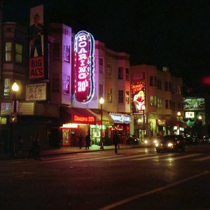 Vibrant Neon Signs Illuminate A Street Scene In Downtown San Francisco At Night.