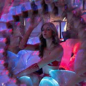 Surreal Portrait Of Woman In Neon Lit Room With Kaleidoscope Effect, Creating A Psychedelic Fashion Vibe.