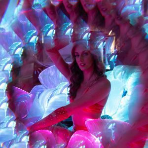 A Vibrant Portrait Of A Woman With A Surreal Kaleidoscope Effect In Neon Lights, Creating A Psychedelic Fashion Look.