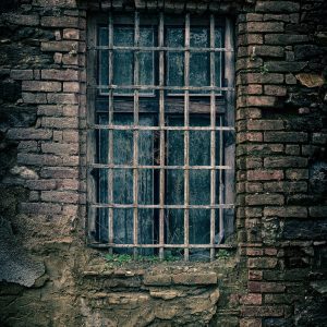 A Moody Close Up Of An Old Brick Wall Featuring A Barred Window, Capturing A Sense Of Nostalgia.