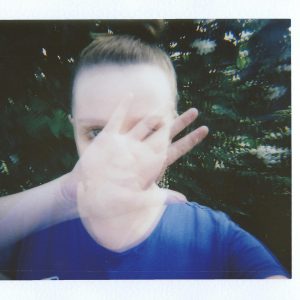 A Creative Double Exposure Instant Film Portrait With Hand Gesture Outdoors.