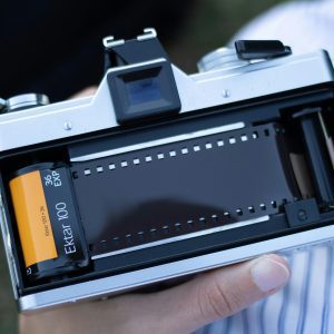 Close Up Of An Open Film Camera With Kodak Ektar 100 Film Roll.
