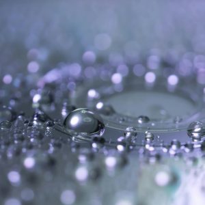 Captivating Macro Photograph Of Water Droplets Highlighting Reflection And Clarity.