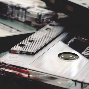 A Nostalgic Close Up Of Overlapping Vintage Cassette Tapes, Highlighting Retro Audio Technology.